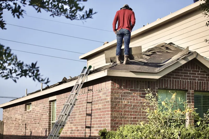 Professional roofer working on a residential roof in Wells Point